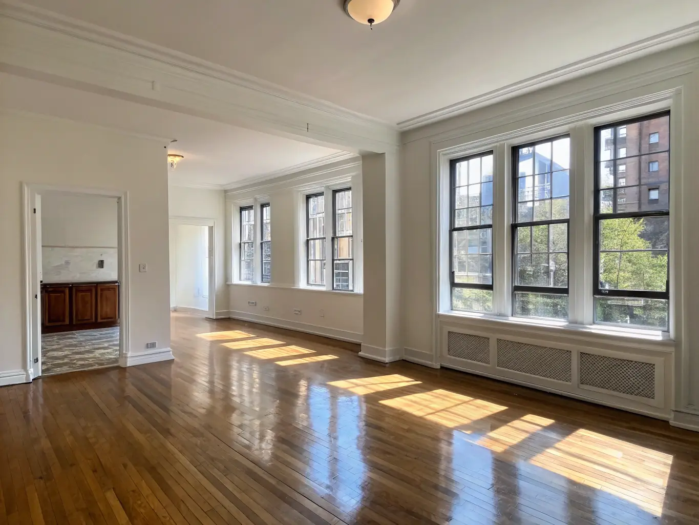 An empty, clean apartment with freshly cleaned floors and windows, ready for new occupants, representing a move-in/move-out cleaning service.